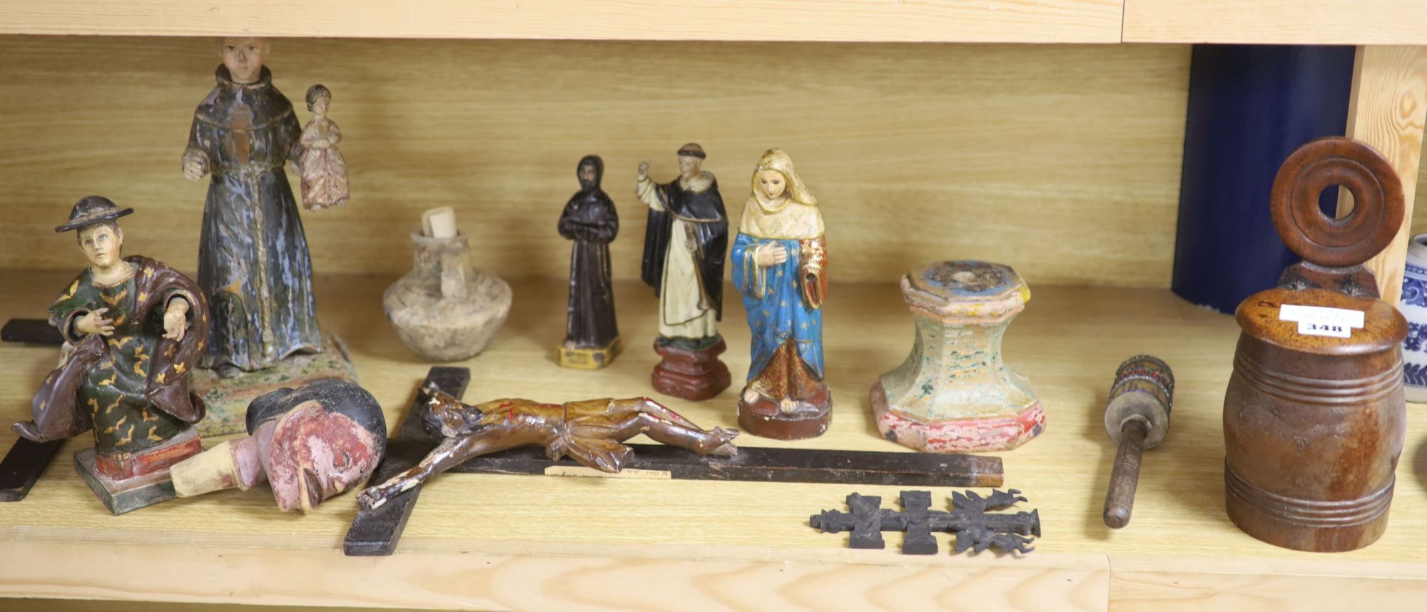 A collection of Spanish/South American carved wood or composition figures of Saints, salt box etc, tallest 30cm